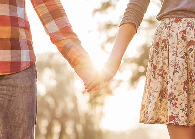 Taking a break from sex - A couple walking in sunset and holding hands