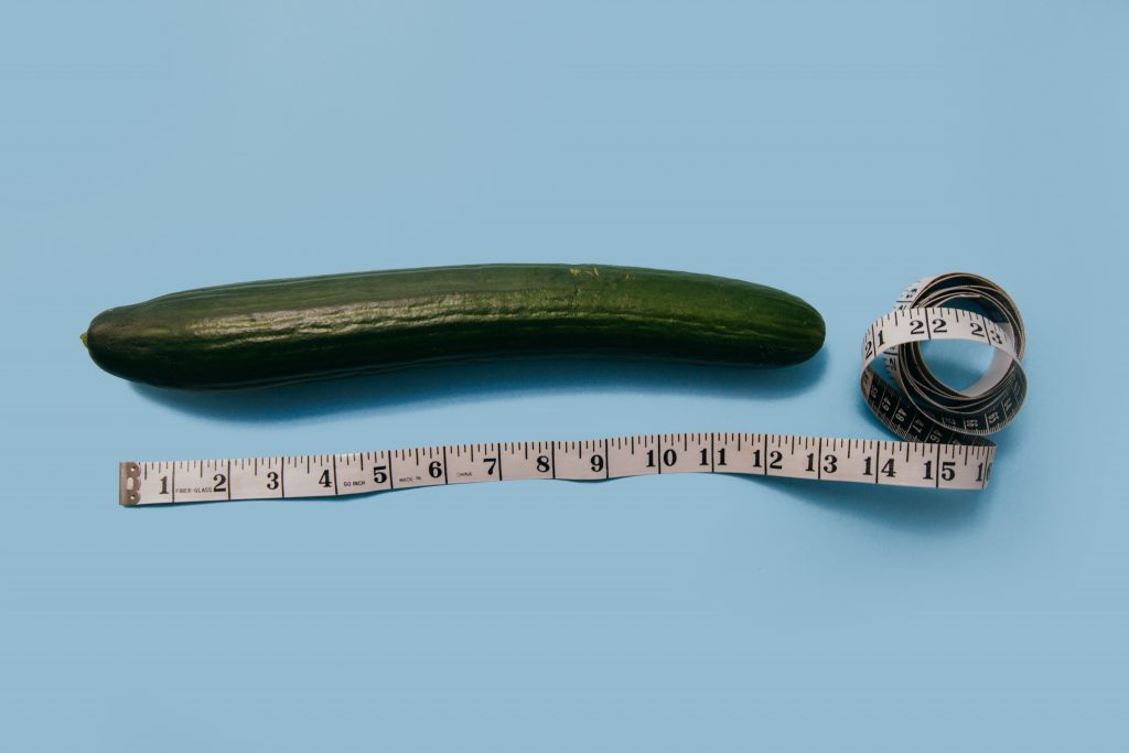 Mind-Blowing Blow Job. Cucumber on table with measuring tape below it.