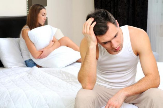 man-sitting-on-edge-of-bed
