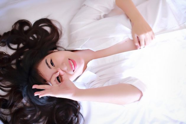Bi-cycle. Woman lying on back looking at camera